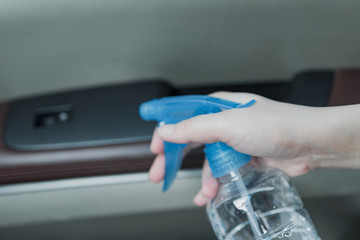 Asian women disinfect and clean car interior