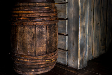 Wooden wine barrel in the basement against the wall.