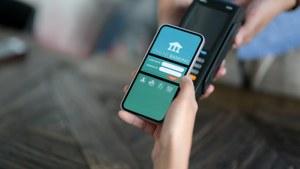 Cropped shot of male customer paying by online banking application