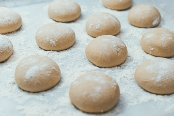 Fototapeta na wymiar Homemade dough pies on the baking sheet ready for the oven for baking