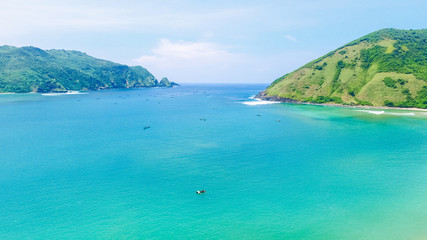 Aerial drone, bird's eye view photo from north of Mawun beach, Lombok Island, Indonesia. Green hills and blue sky. View of another side of mandalika circuit in Lombok. Background of beach Lombok.