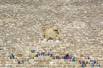 Cairo, EGYPT- JANUARY 19, 2019 : Tourists climb the Great Pyramid of Cheops. Pyramid entrance.