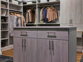 walk in closet with clothes hanging and shoes on shelving