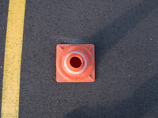 Traffic cone with shadow on asphalt