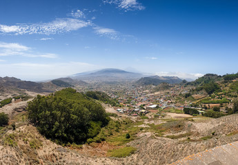 Panoramic image of small town on the mountain slope at valley