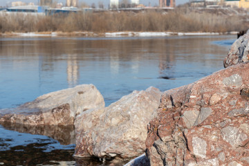 Large stone boulders with granite rocks near the river