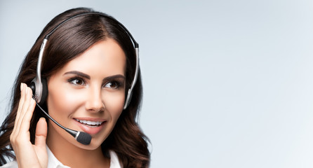 Portrait of cheerful customer support female phone operator in headset