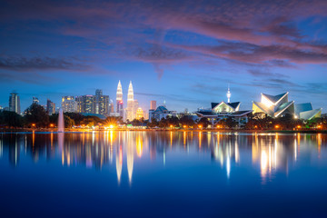 Fototapeta na wymiar Kuala Lumpur city skyscraper and fountation with nice sky twilight at Titiwangsa Park in Kuala Lumpur. Malaysia. Travel and Vacation concept.