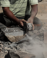 close up image of hands of a young man giving stone sculpture at pune 