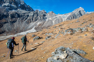 Fototapeta premium Group of trekker with rugged landscape on the way to climbing Renjo la pass (5,340 m) during trekking in Sagarmatha national park, Nepal.