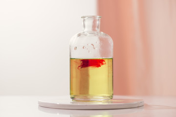 Red color dropping into a bottle of water