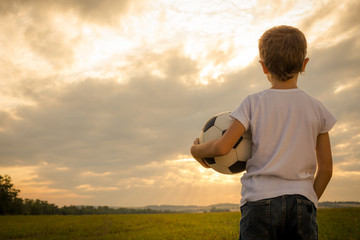 Portrait of a young  boy with soccer ball. - Powered by Adobe
