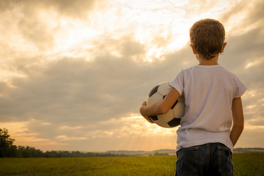Portrait of a young  boy with soccer ball.