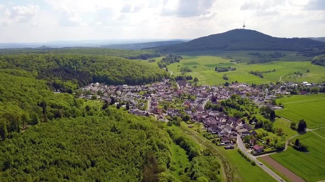 German forest in May in the area of Hessen, Biebertal by drone on a suny day.