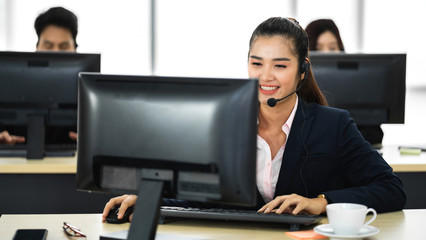 Group of happy smiling business operator customer support team phone services working with headset...