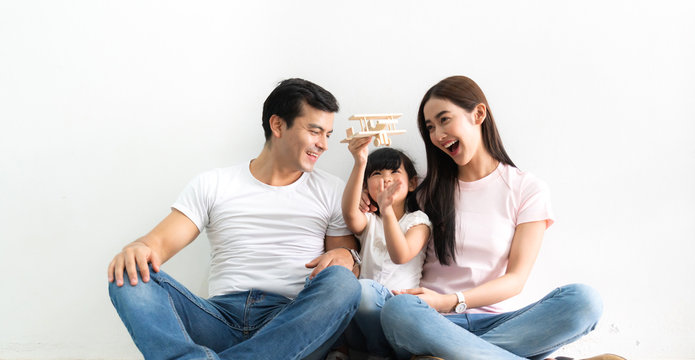 Portrait of happy asian family father and mother with daughter on white background