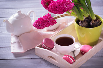 Pink macaroon with pink  hyacinth on the wooden background