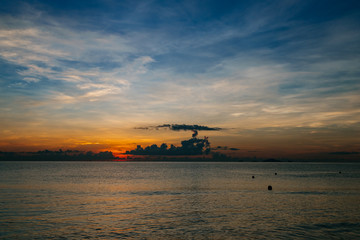 Obraz premium Sunrise, sunset of the sun through the clouds, tropical area near sea.
