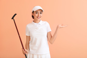 Beautiful female golfer on color background