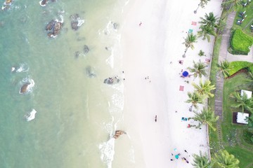 Top view of beautiful beach with tourist, aerial drone shot