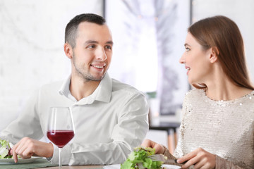 Happy young couple on romantic date in cafe