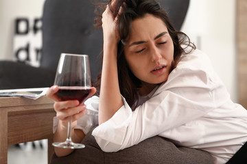 Obraz na płótnie Canvas Woman drinking wine at home. Concept of alcoholism