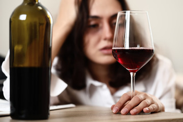 Woman drinking wine at home. Concept of alcoholism