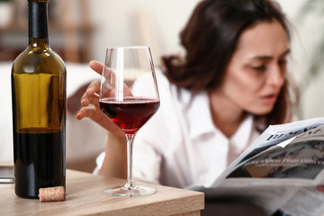 Woman drinking wine at home. Concept of alcoholism