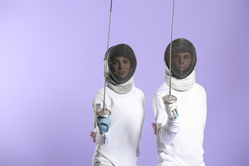 Young fencers on color background