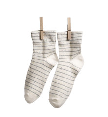 Cotton socks hanging on rope against white background