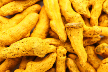 Many turmeric roots as background