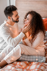 Happy young couple in bedroom