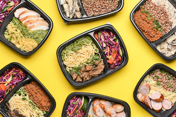 Containers with healthy food on color background