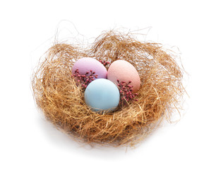 Nest with beautiful Easter eggs on white background