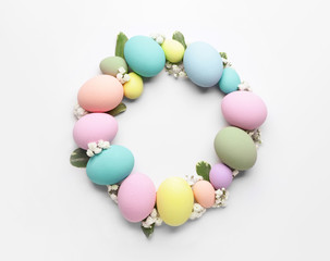 Frame made of beautiful Easter eggs on white background