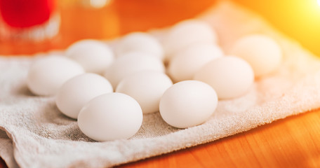 Many white eggs lying on napkin prepare for paint. Happy easter.