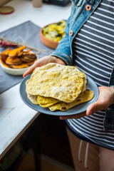 Chapati naan paratha flatbread. Woman holds Indian homemade bread. Vegan healthy diet food.