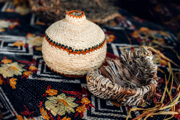 Different hand made weave basckets on table. Craft workshop. Close up shot.