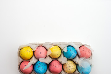 Fototapeta na wymiar Multicolored Easter eggs on a white background. Top view, copy space.