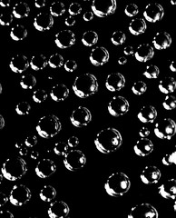 Air balls in water on a black background