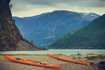 Kayaks on fjord shore, Flam, Norway