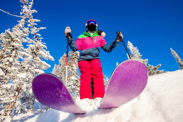 Skier skiing downhill in high mountains winter forest