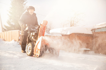 City service cleaning snow winter with thrower blower machine after snowstorm yard