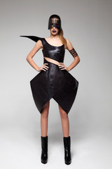 brunette model in high fashion, detailed, black leather dress and futuristic holographic mask ....