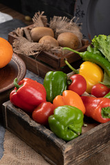 Colorful bell peppers in a rustic tray.
