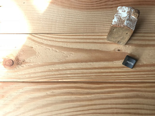 white roof ceramic house with home black button from computer keyboard put on natural rubber wood...
