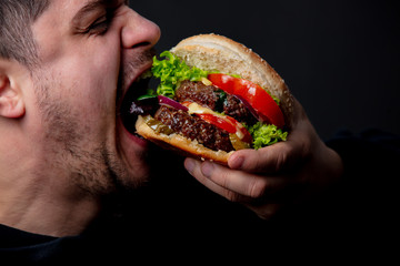 guy eating classic american burger