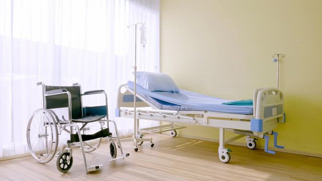 Bedroom for patient in a hospital, Empty bed and wheelchair on hospital ward