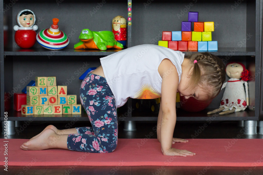 Wall mural little girl making yoga cat pose