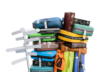 Travelling suitcases piled up with empty direction sign pole isolate on white